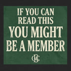Black t-shirt with green text and logo on a white background