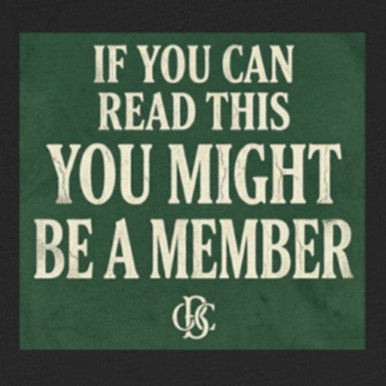 Black t-shirt with green text and logo on a white background
