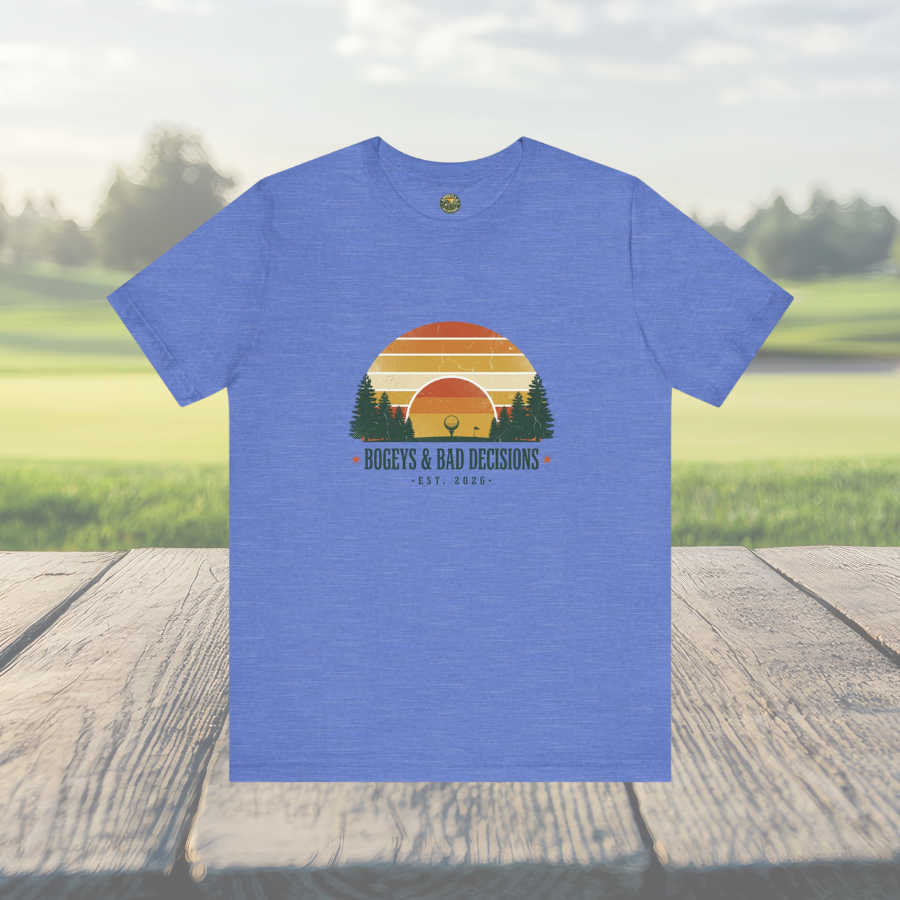 Blue t-shirt with a graphic design on a wooden surface with a grassy field background